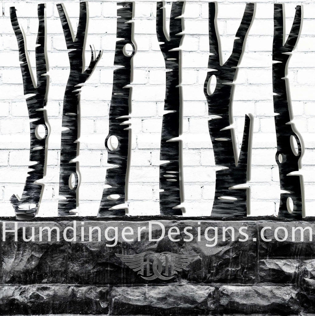 Six Birch Trees made out of Aluminum and painted black and silver perched on a black brick wall - humdinger designs